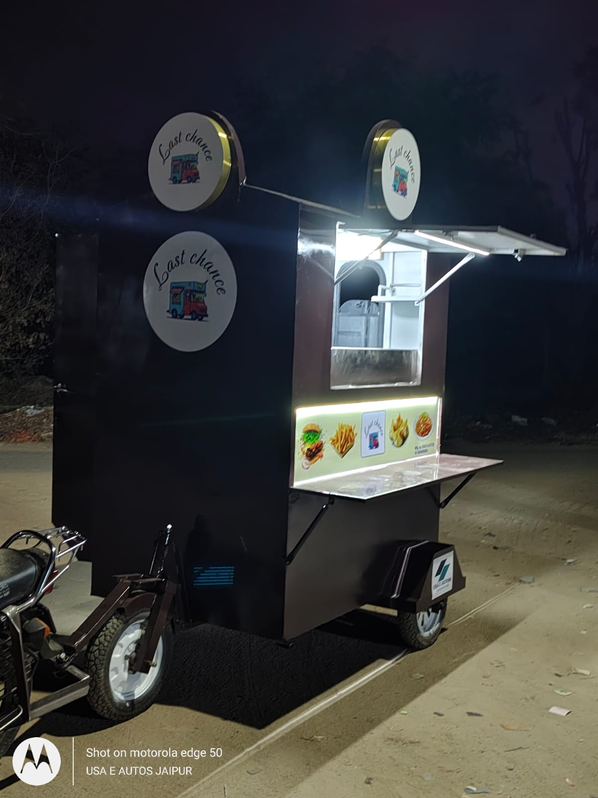 Gurukripa EV cart with its counter lit at night